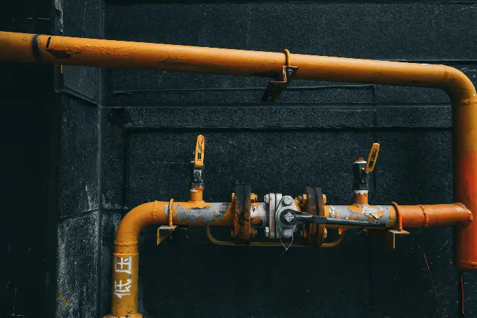 brass pipe with pipe on black wall